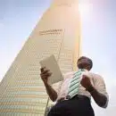 man standing near high-rise building