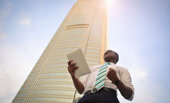 man standing near high-rise building